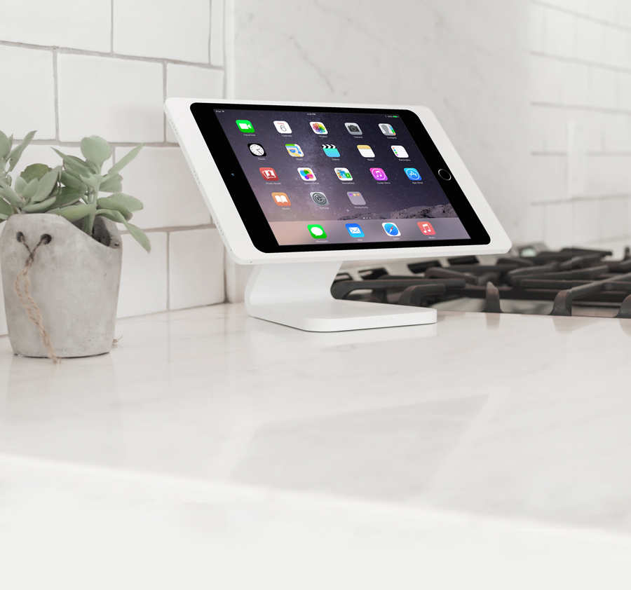 White iPad wireless charging and mounting solution by IPORT on a kitchen counter.