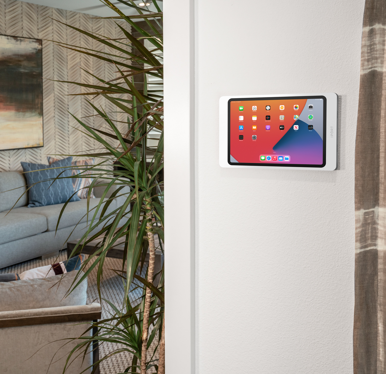 Surface Mount, the silver iPad wall mount by IPORT installed in a home.