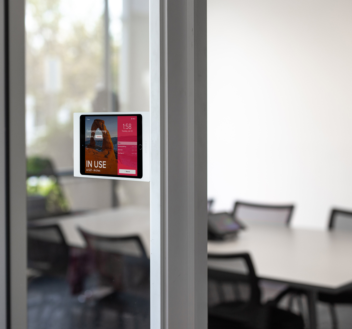 Side Mount, the iPad wall mount for business, mounted on a class door in a corporate office.